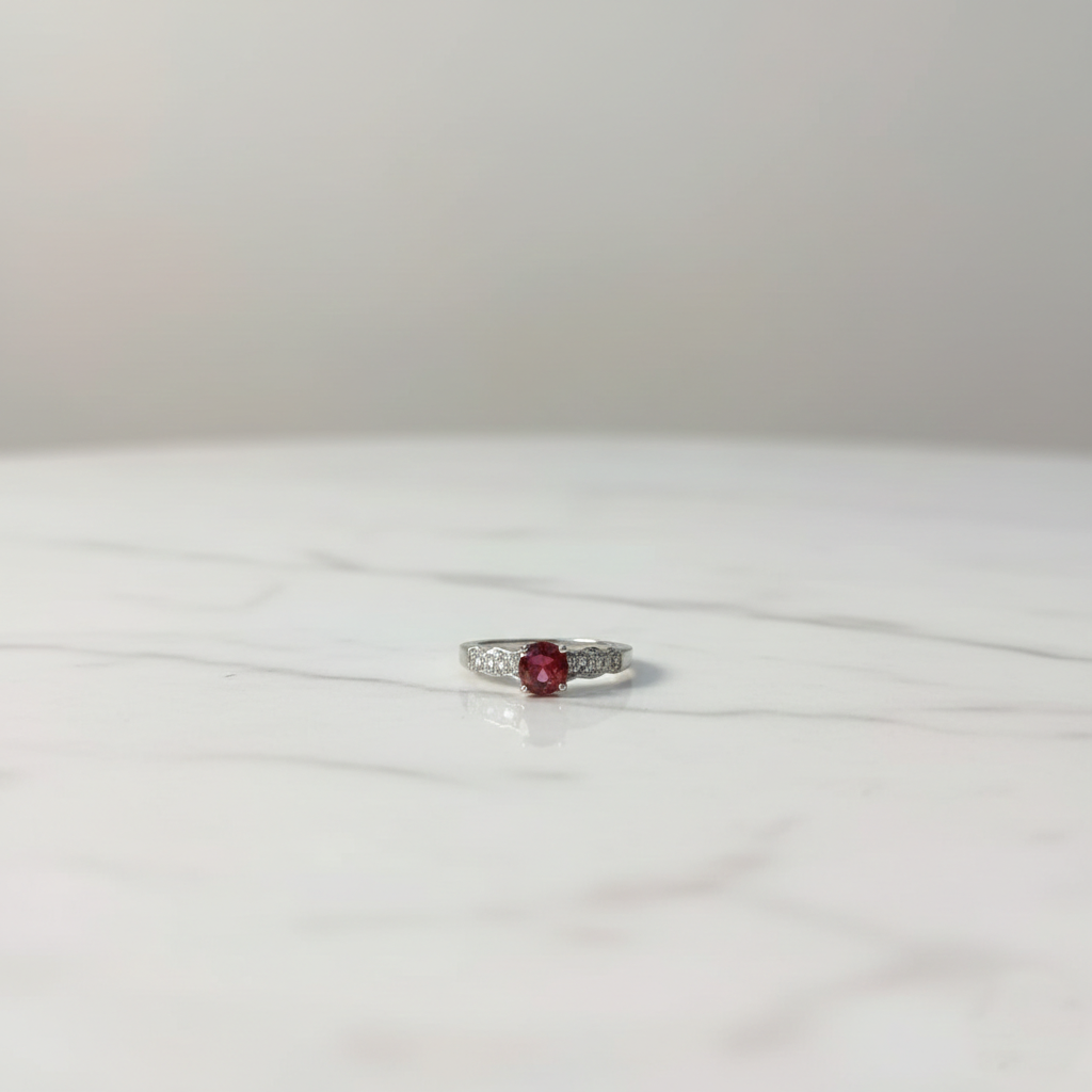 Silver ruby solitaire ring with diamond accent side stones, elegant luxury design