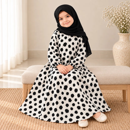 white kids abaya with a small black abstract spot print
