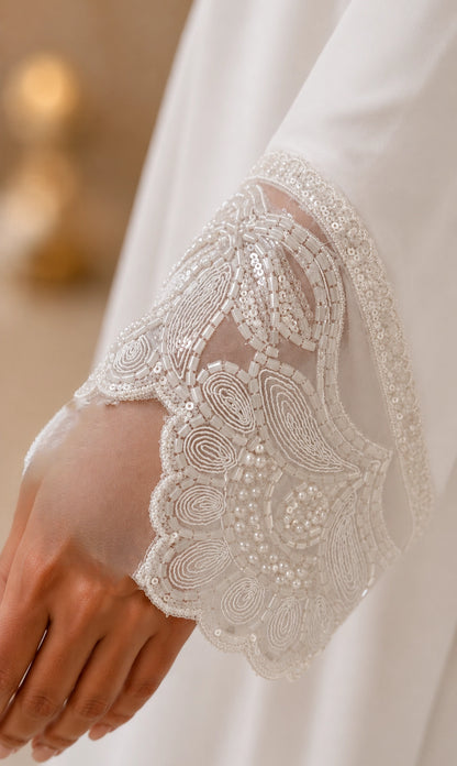 Pure white georgette abaya with hand embroidered pearl cuffs and hidden front button patti.  