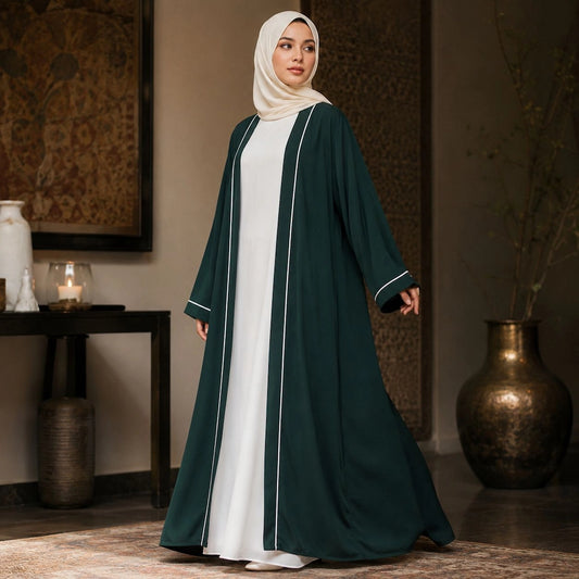 Woman wearing emerald green open front abaya with white piping and inner dress, modest 2 piece abaya set
