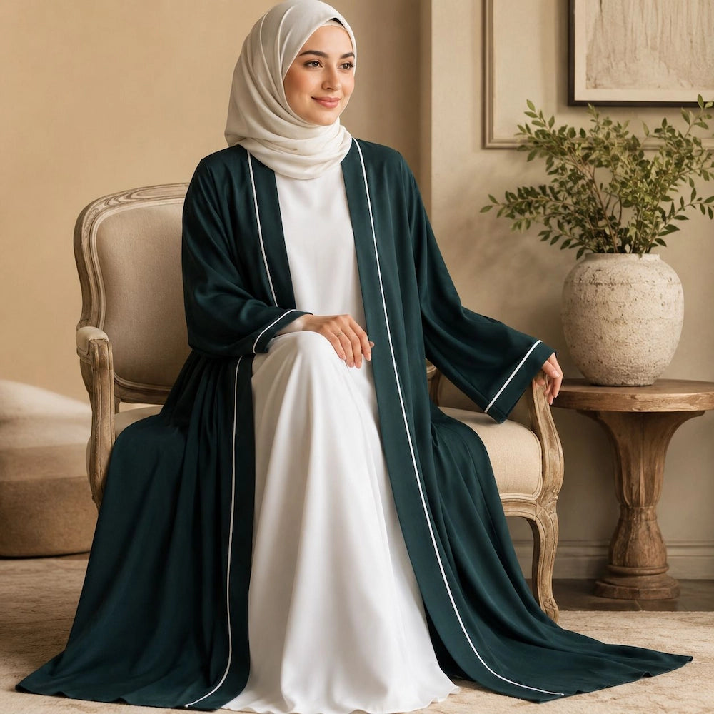 Woman wearing emerald green open front abaya with white piping and inner dress, modest 2 piece abaya set