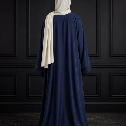 Model wearing premium navy closed nida abaya with attached inner and delicate lace sleeve detailing