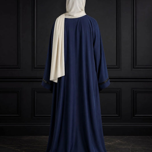 Model wearing premium navy closed nida abaya with attached inner and delicate lace sleeve detailing
