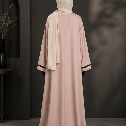 Model wearing premium nude beige closed nida abaya with attached inner and lace sleeve detailing