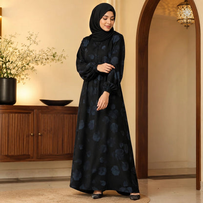 Woman wearing jet black floral abaya with subtle blue floral print, elastic cuffs and front buttons