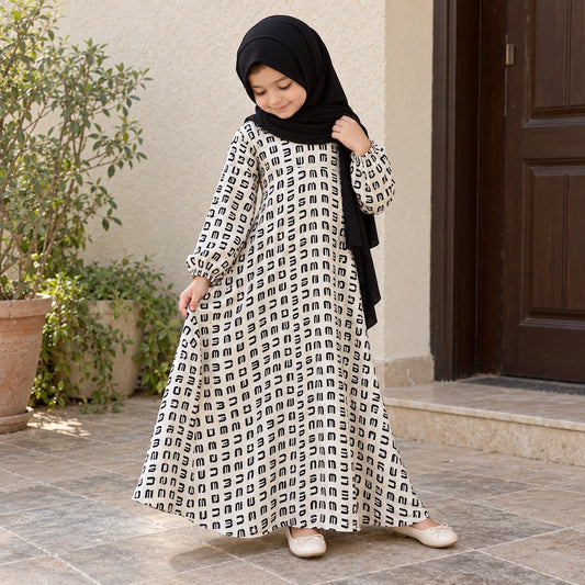 White crepe chiffon girls’ abaya with a small black dash print and flared shape