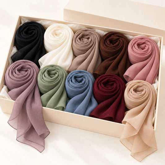 Ten georgette hijabs in black, ivory, taupe, brown, rose, mauve, sage, blue, burgundy and beige, arranged in two rows.