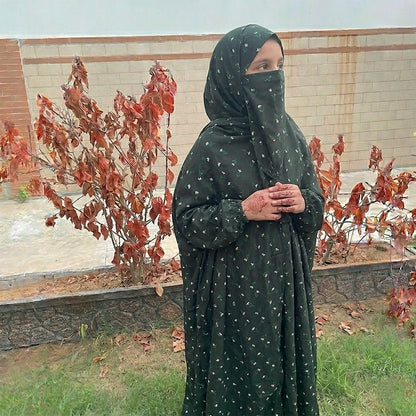 Young girl in a black and green flower namaz chaddar