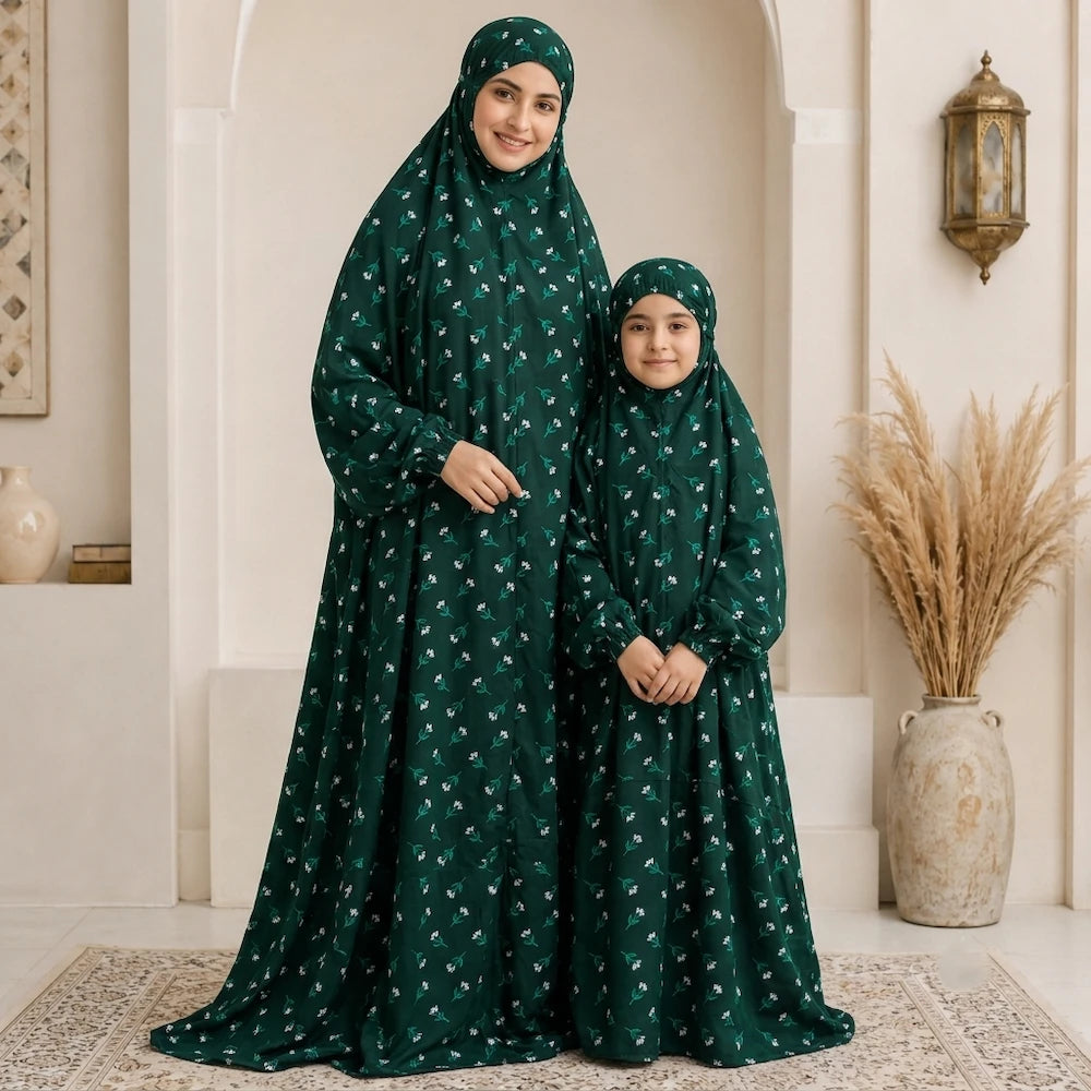 Mother daughter in same namaz chaddar in green and white pattern flowers