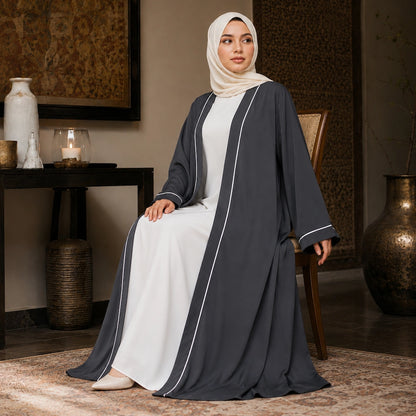 Woman wearing grey open front abaya with white piping and separate inner dress
