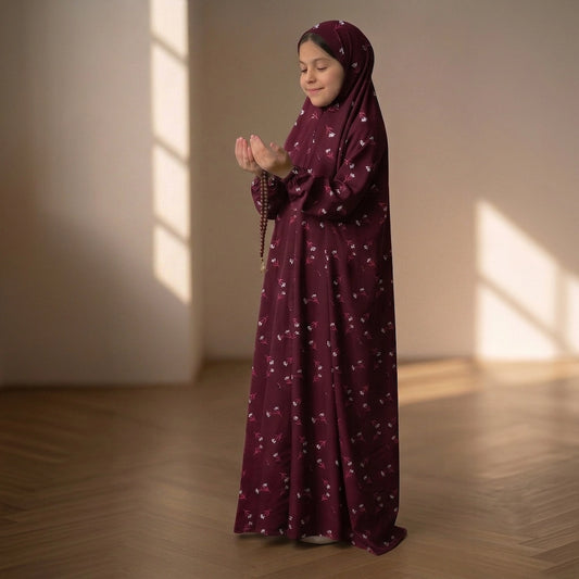 namaz chaddar with a small white floral pattern, standing in a sunlit room with wooden floors.