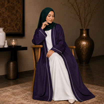 Woman wearing purple open front abaya with white piping and separate inner dress