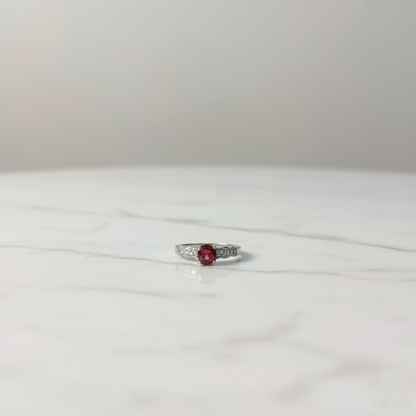 Silver ruby solitaire ring with diamond accent side stones, elegant luxury design