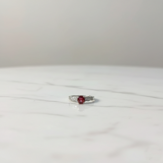 Silver ruby solitaire ring with diamond accent side stones, elegant luxury design