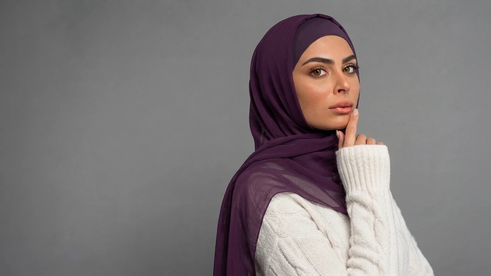 A woman wearing a deep purple built in magentic  hijab
